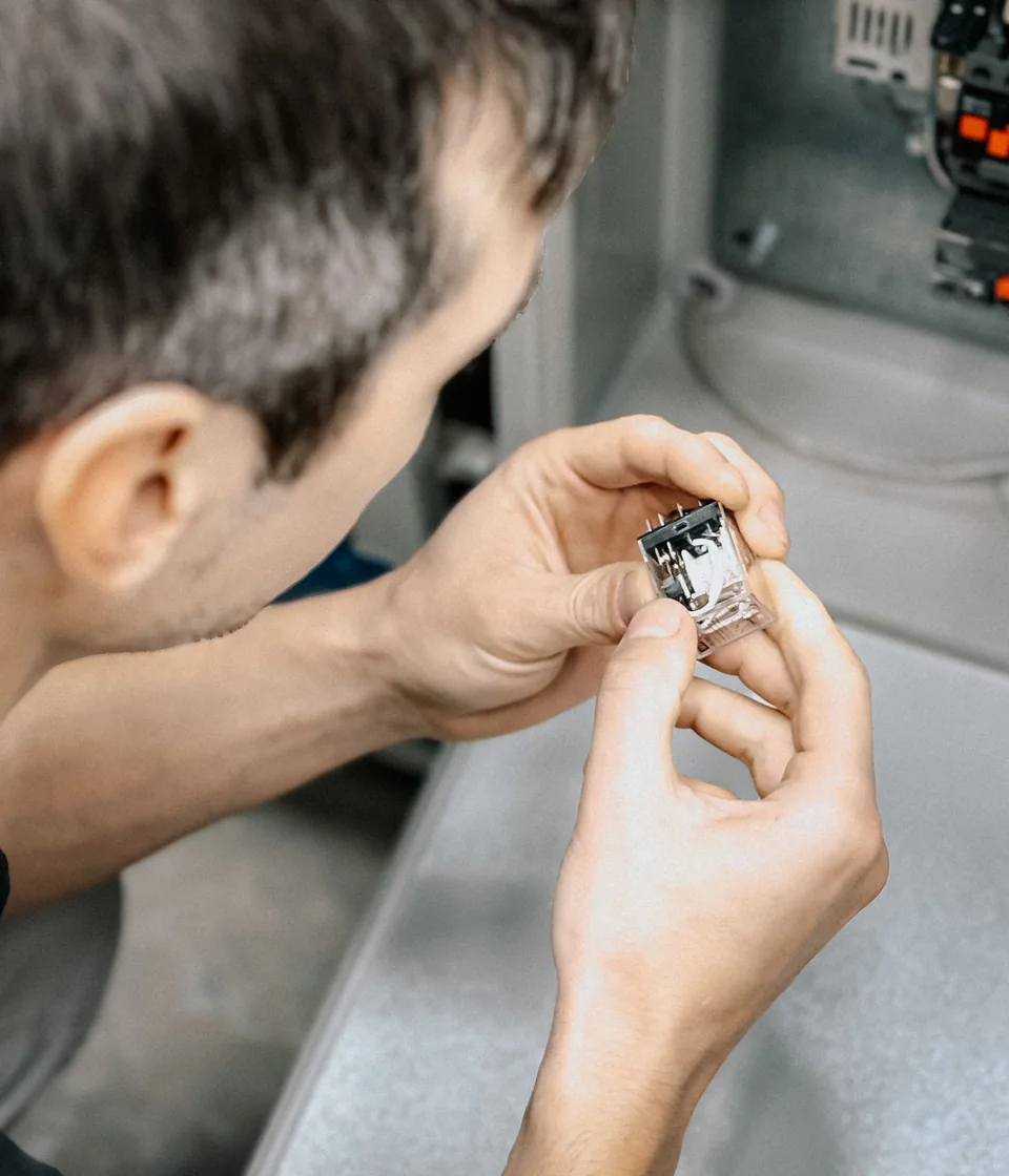 Illustrative technician examining precision electronics equipment