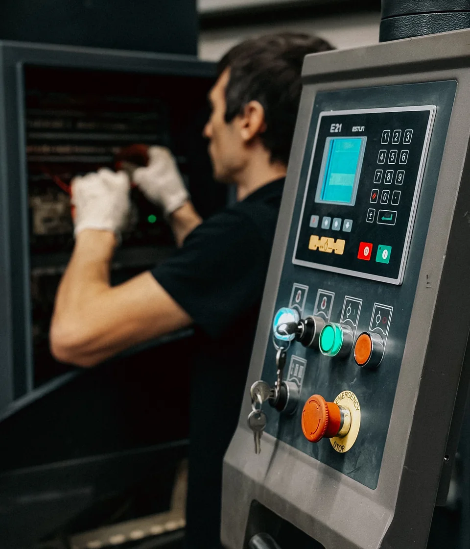 Illustrative technician operating an industrial machine control panel